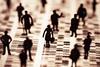 The image shows silhouette humans against a digital data backdrop
