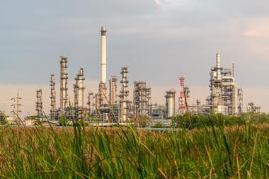 A chemical plant with grass in the foreground