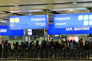 Air travelers queue at border control at Heathrow Airport. Passengers from the EU face uncertainty as the UK government is poised to trigger article 50 to initiate brexit, March 14, 2017.