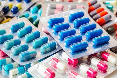 A photograph of packs of drug capsules